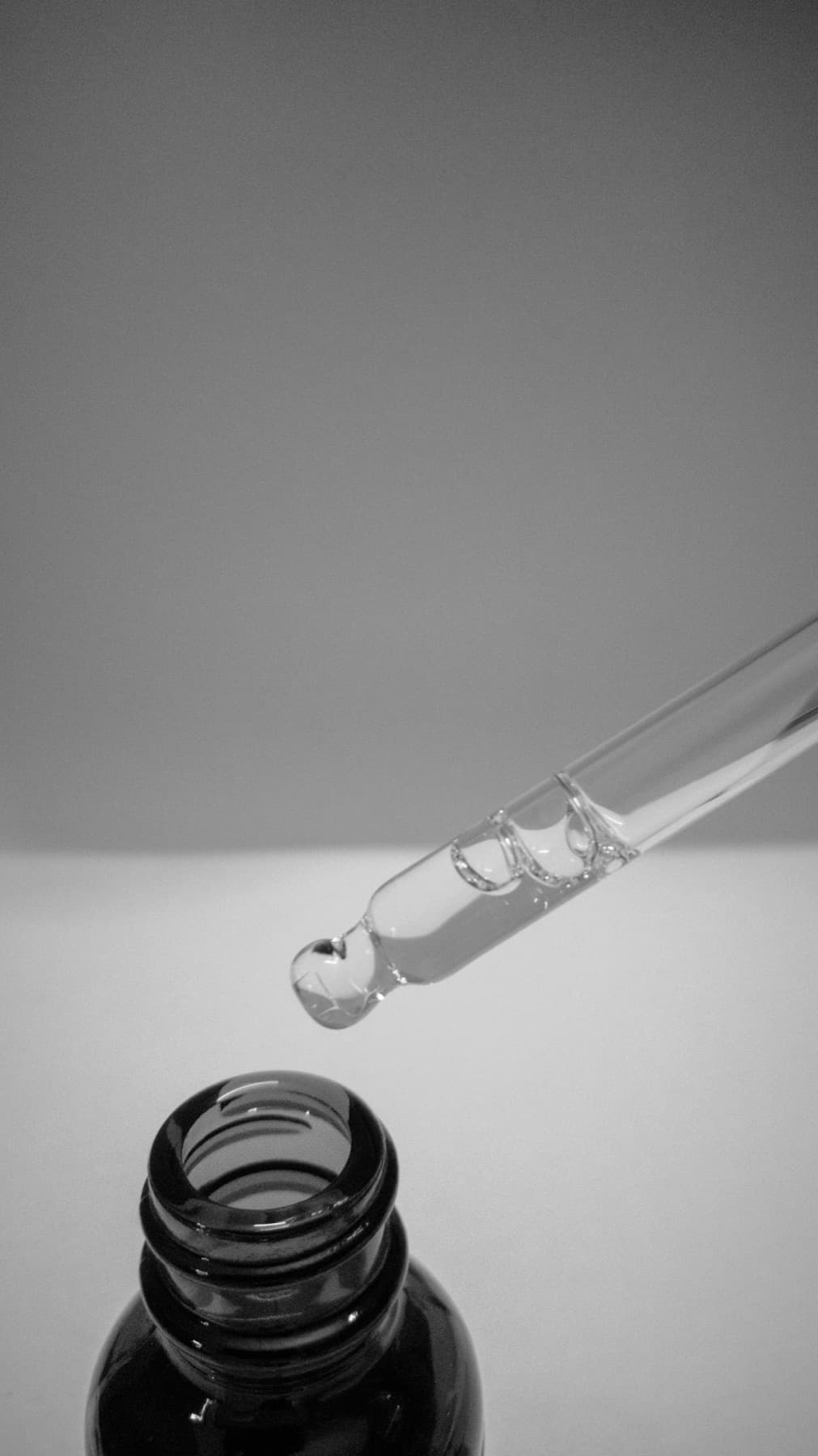 A single smear of white cream drawn across a bare beige surface.